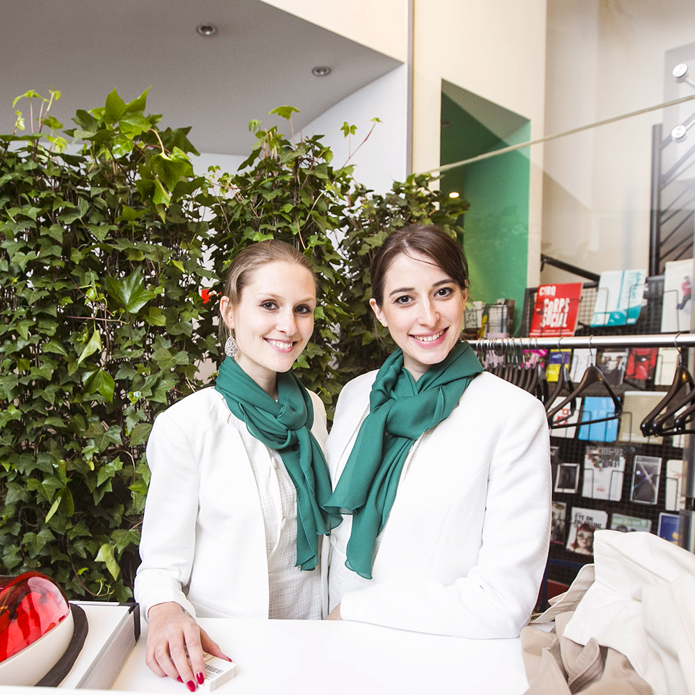 Xtravia Smiling young women welcoming clients